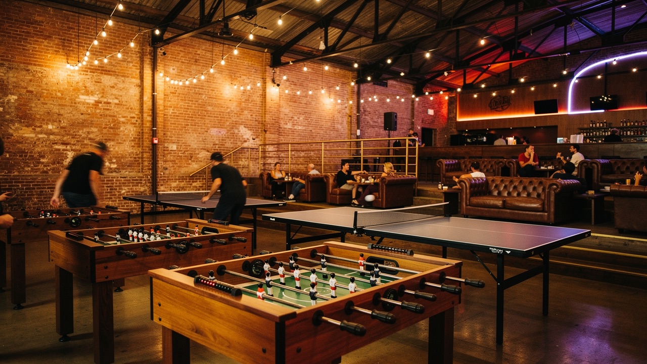 Concept render — foosball row beside ping pong tables mid-rally